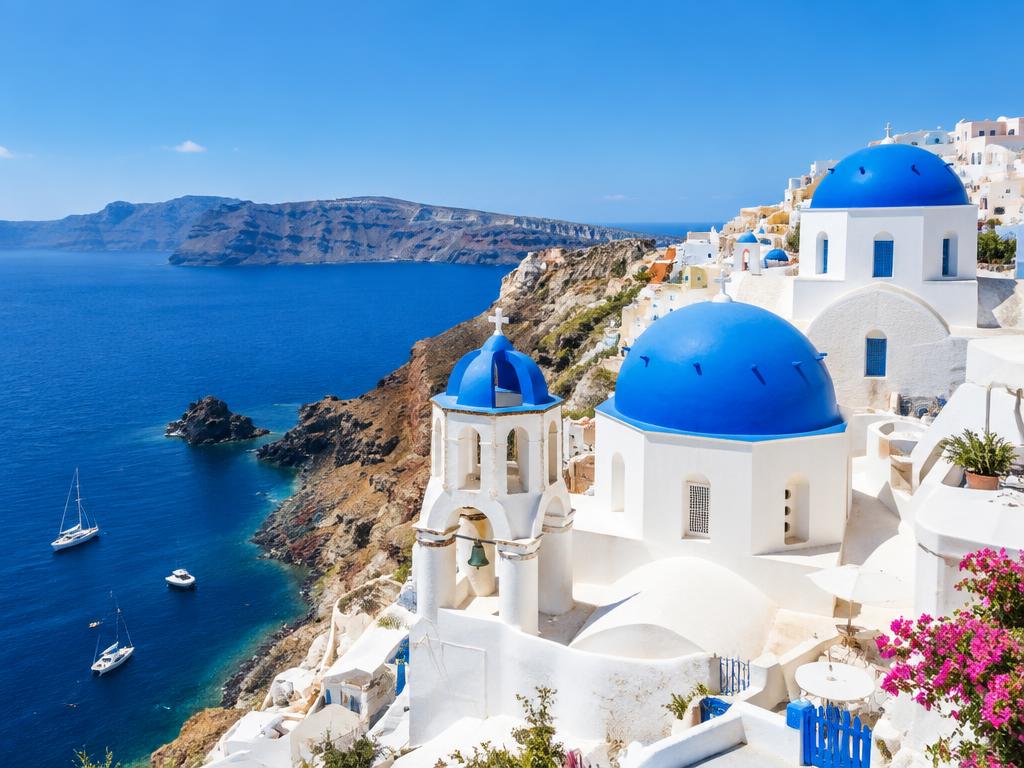 Blue-domed churches and whitewashed buildings in Santorini, Greece