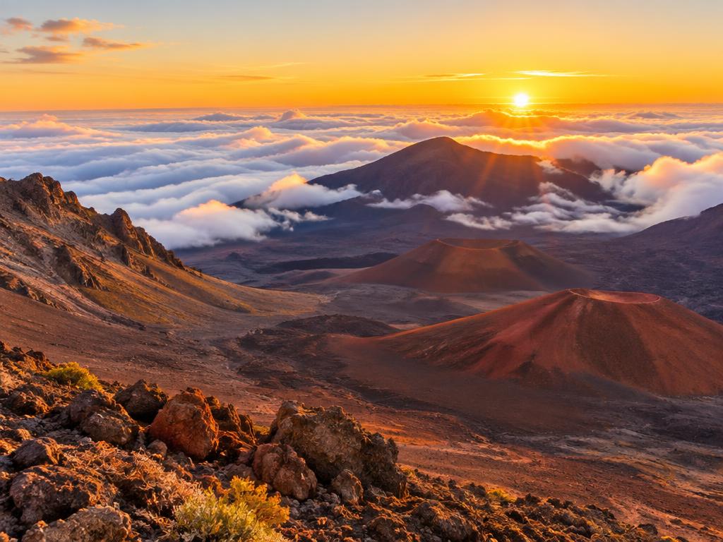 Sunrise over the clouds and cinder cones of Haleakalā crater
