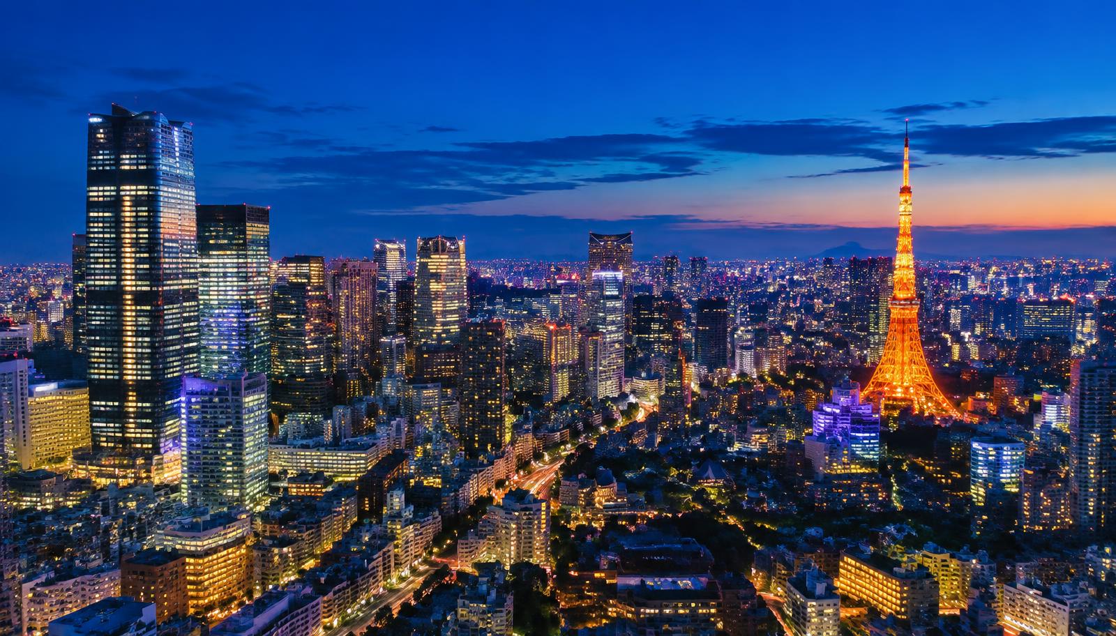 Tokyo skyline at dusk with glowing skyscrapers and city lights